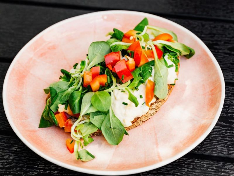 Delicious open-faced sandwich with fresh vegetables on whole grain bread, perfect for a healthy meal.